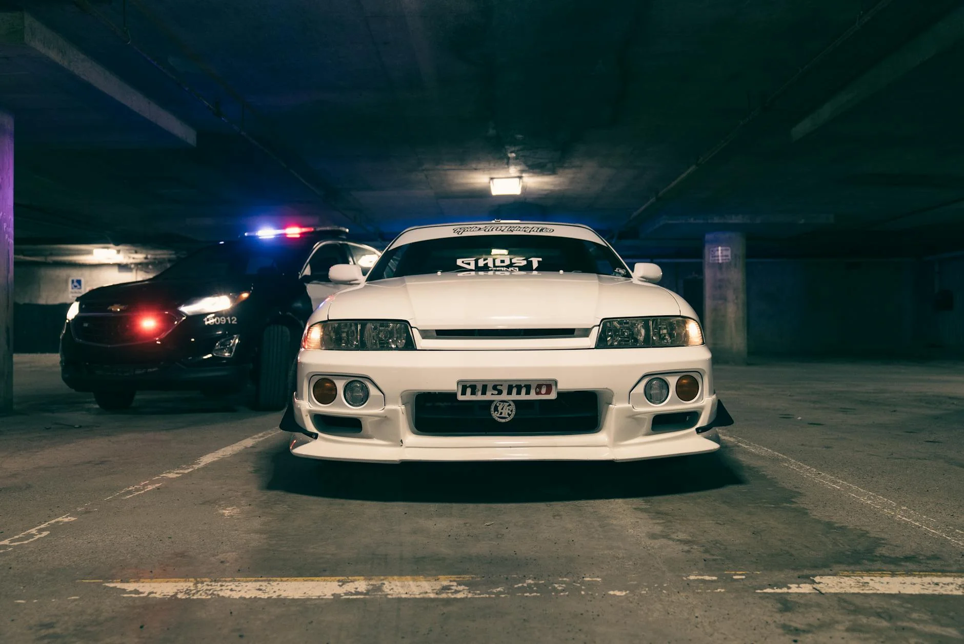 police car chasing sports car on highway night pursuit