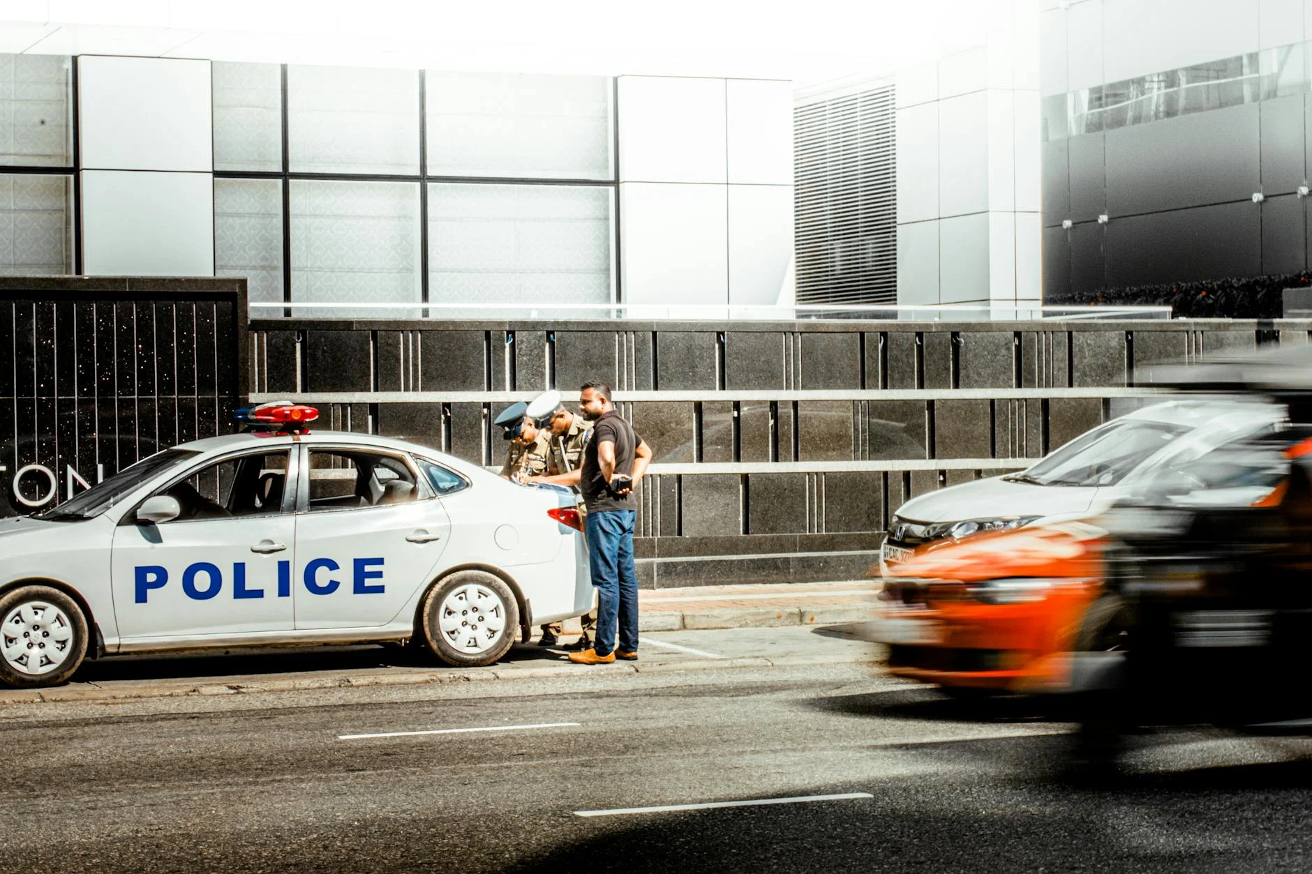 police helicopter spotlight pursuing sports car urban street