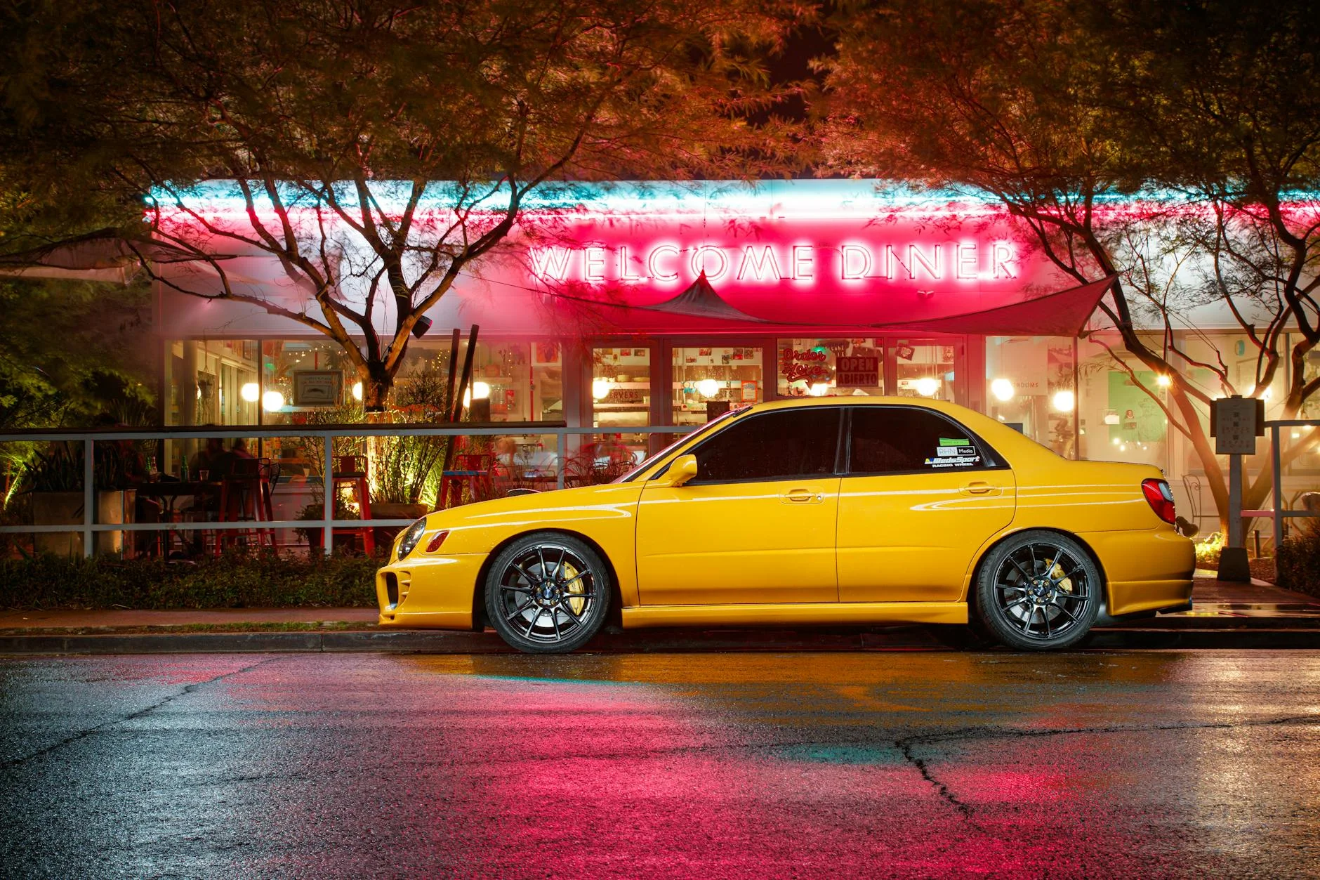 night parking lot cars meet diner neon lights